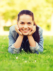 Image showing smiling young girl lying on grass