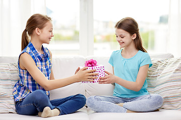 Image showing happy little girls with birthday present at home