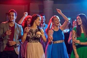 Image showing happy friends with glasses of champagne in club