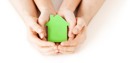 Image showing man and woman hands with green paper house