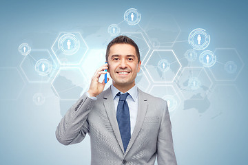 Image showing happy businessman calling on smartphone