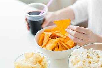 Image showing close up of woman with junk food and coca cola cup