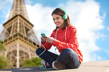 Image showing happy young woman with smartphone and headphones