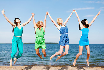 Image showing girls jumping on the beach