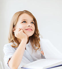 Image showing student girl writing in notebook at school