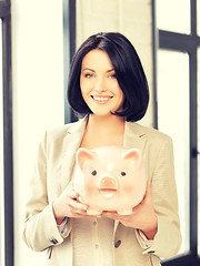 Image showing lovely woman with piggy bank