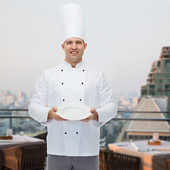 Image showing happy male chef cook showing empty plate