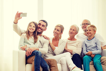 Image showing happy family with smartphone at home