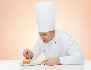 Image showing happy male chef cook decorating dessert