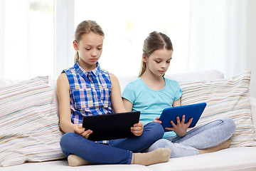 Image showing girls with tablet pc sitting on sofa at home