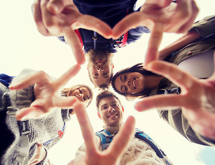 Image showing group of smiling friends with backpacks hiking