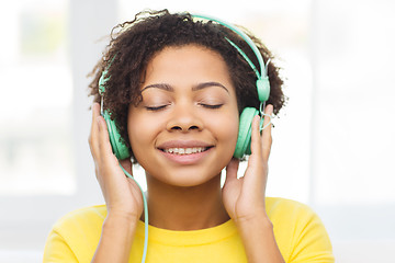 Image showing happy woman with headphones listening to music