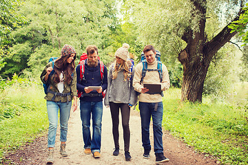 Image showing group of friends with backpacks and tablet pc