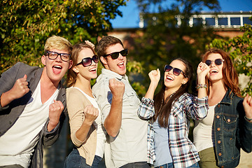 Image showing group of happy friends showing triumph gesture