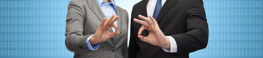 Image showing businessman and businesswoman showing ok sign