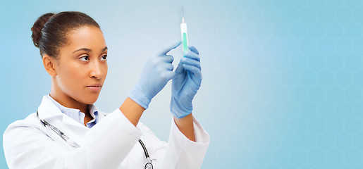 Image showing african doctor holding syringe with injection