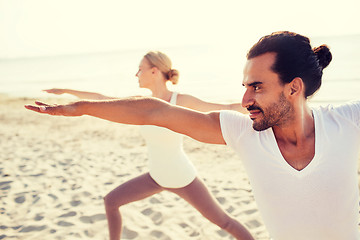 Image showing close up of couple making yoga exercises outdoors