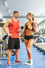 Image showing smiling man and woman talking in gym