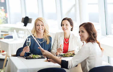 Image showing women with smartphone taking selfie at restaurant