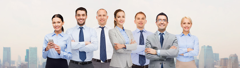 Image showing group of happy businesspeople with crossed arms