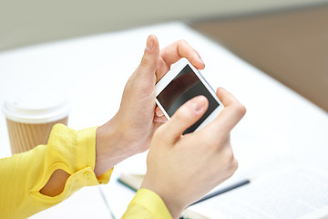 Image showing close up of female hands with smartphone at home