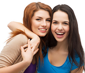 Image showing two laughing girls hugging