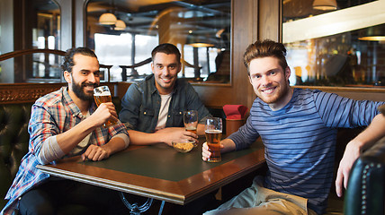 Image showing happy male friends drinking beer at bar or pub