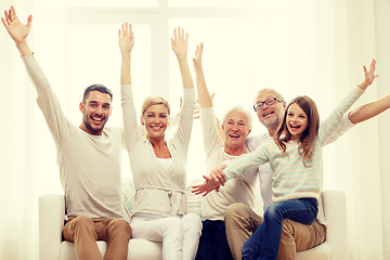 Image showing happy family sitting on sofa at home