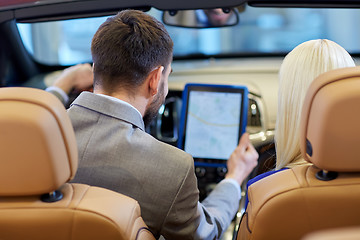 Image showing couple sitting in cabriolet car with tablet pc