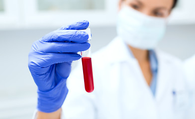 Image showing close up of scientist holding test tube in lab