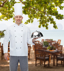 Image showing happy male chef cook holding cloche