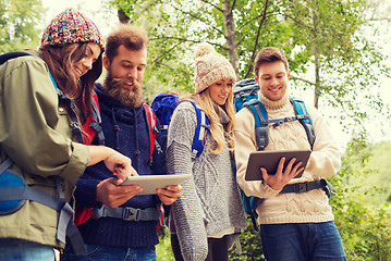 Image showing group of friends with backpacks and tablet pc