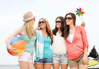 Image showing smiling girls in shades having fun on the beach