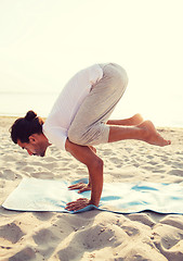 Image showing man doing yoga exercises outdoors