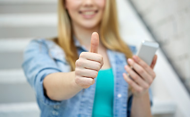 Image showing female with smartphone showing thumbs up