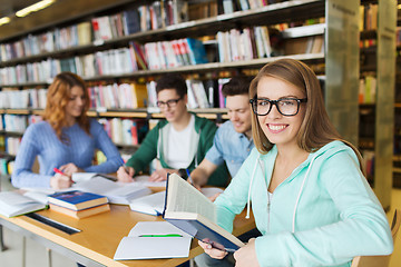 Image showing happy students reading books in library