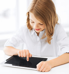 Image showing smiling little girl with tablet pc at school