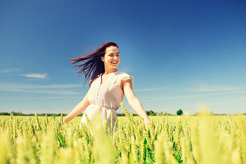 Image showing smiling young woman on cereal field