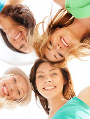 Image showing faces of girls looking down and smiling