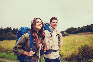 Image showing smiling couple with backpacks hiking