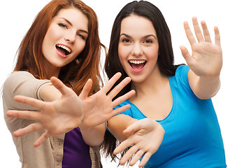 Image showing two smiling girls showing their palms