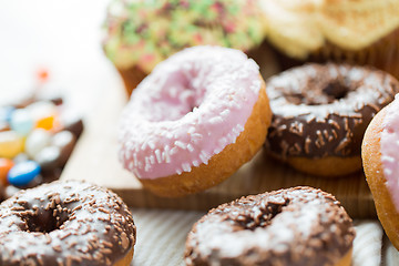 Image showing close up of glazed donuts pile on table