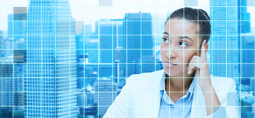 Image showing african businesswoman looking up and thinking