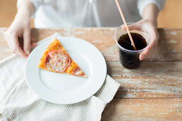 Image showing close up of woman with pizza and coca cola drink