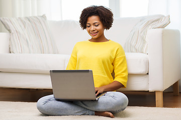 Image showing happy african american woman with laptop at home