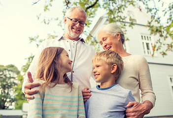 Image showing happy family in front of house outdoors