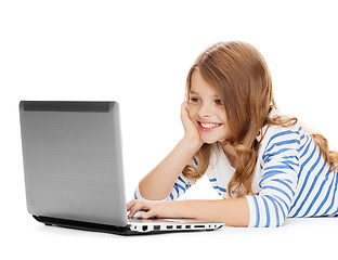 Image showing smiling student girl with laptop computer lying