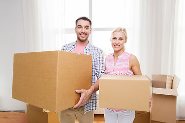 Image showing couple with big cardboard boxes moving to new home