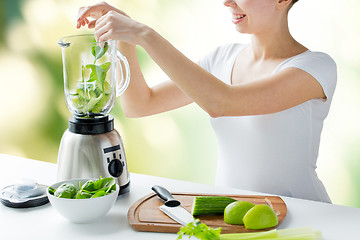 Image showing close up of woman with blender and vegetables