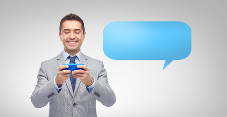 Image showing happy businessman texting message on smartphone